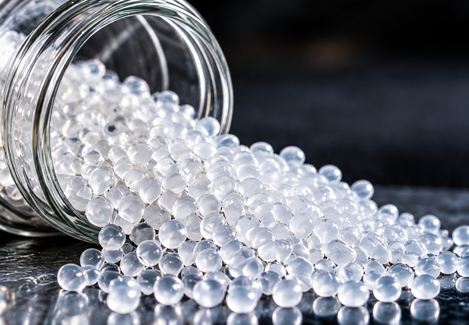 Polylactic acid pellets spilling from a container